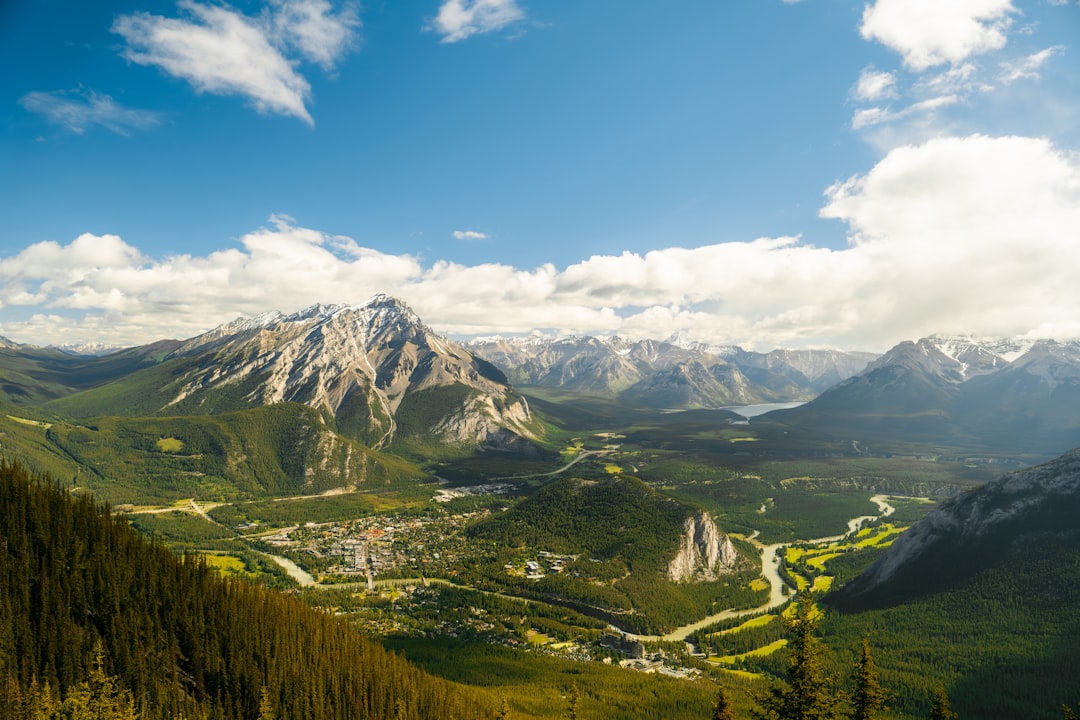 A scenic view of a mountain range with trees and mountains in the background