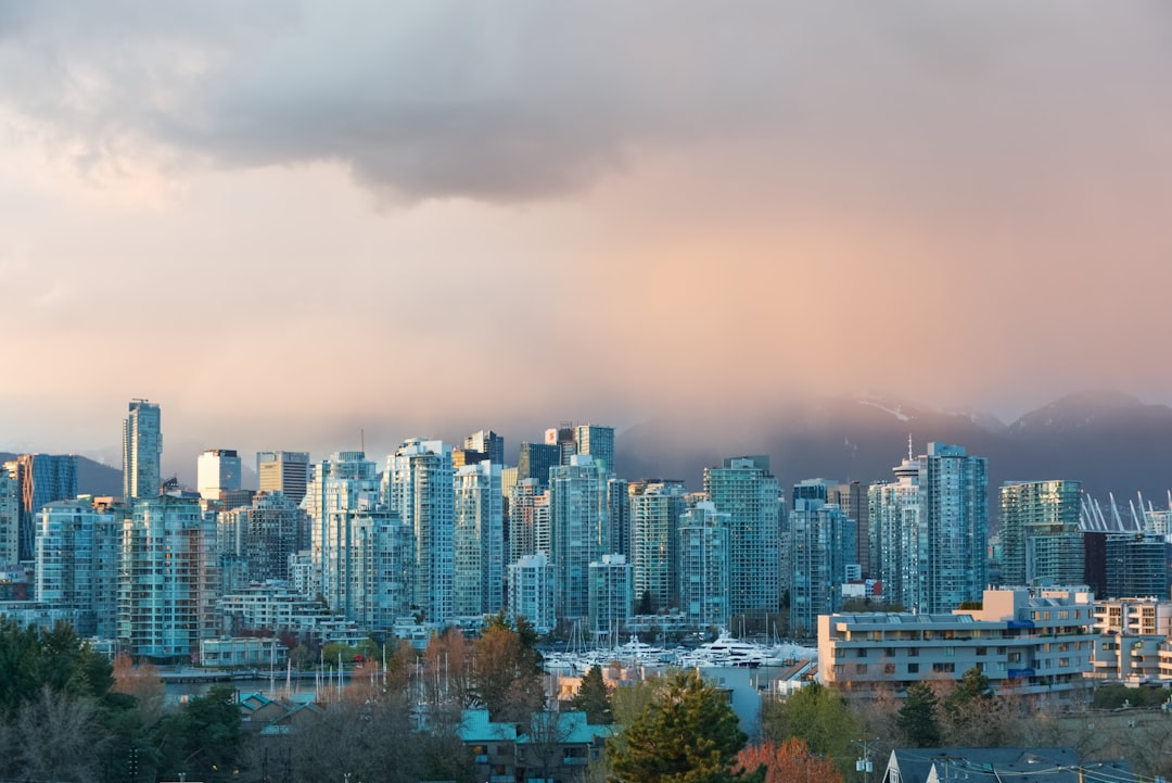 a view of a city with tall buildings under a cloudy sky