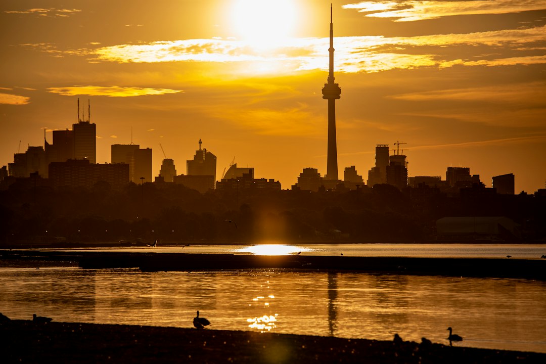 City skyline at sunset with a tall tower