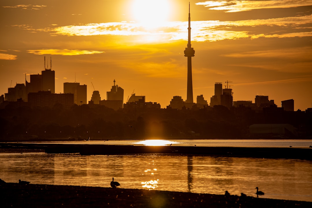 City skyline at sunset with a tall tower