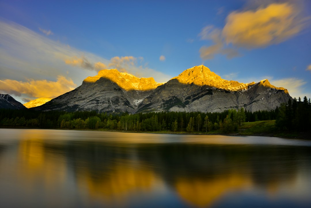 a mountain range is reflected in a lake
