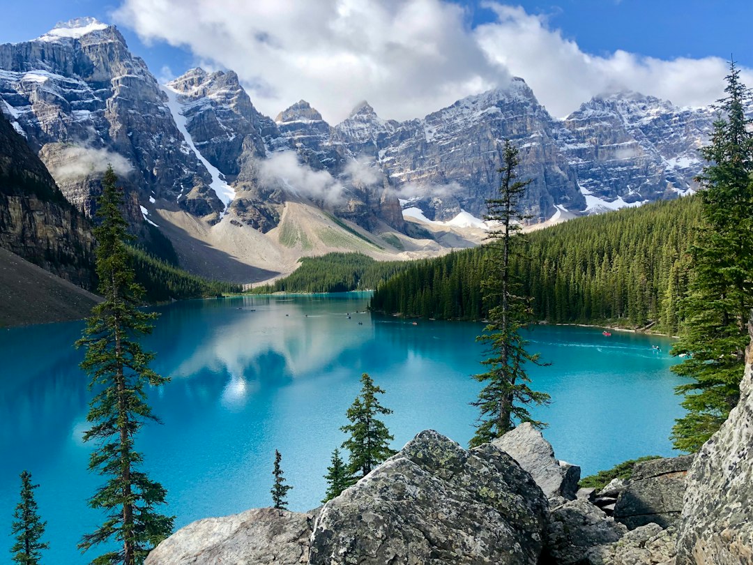 a blue lake surrounded by mountains and trees