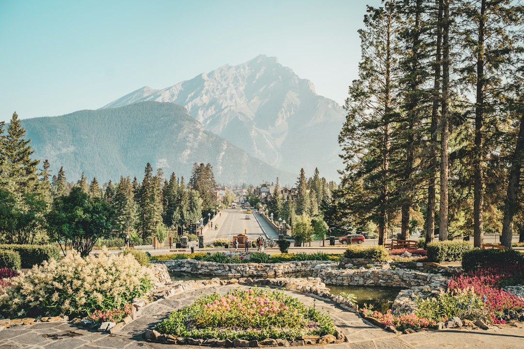 A mountain landscape with a formal garden in the foreground