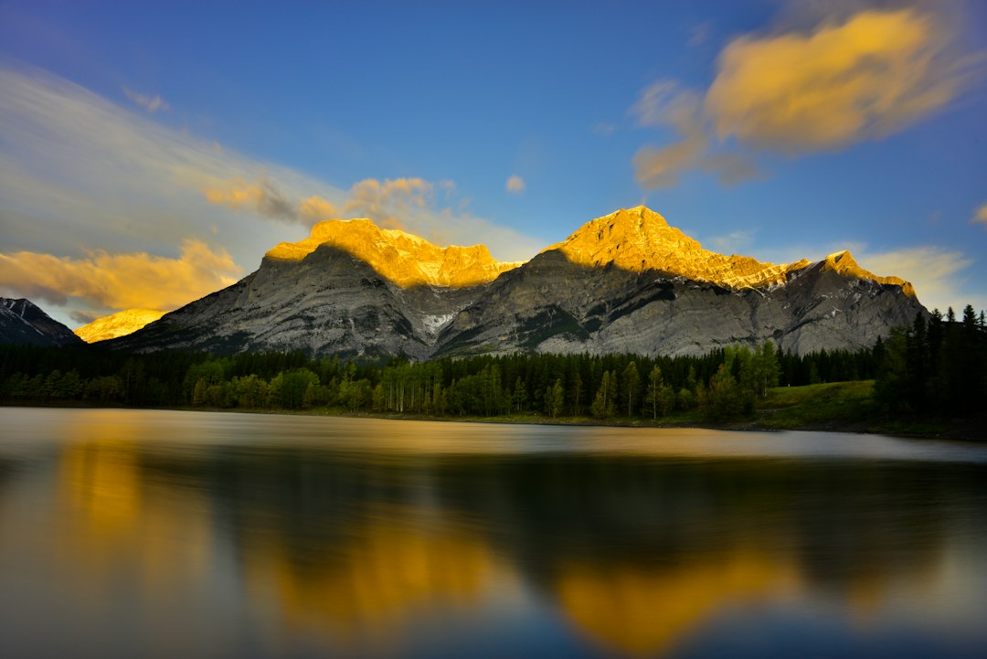 a mountain range is reflected in a lake